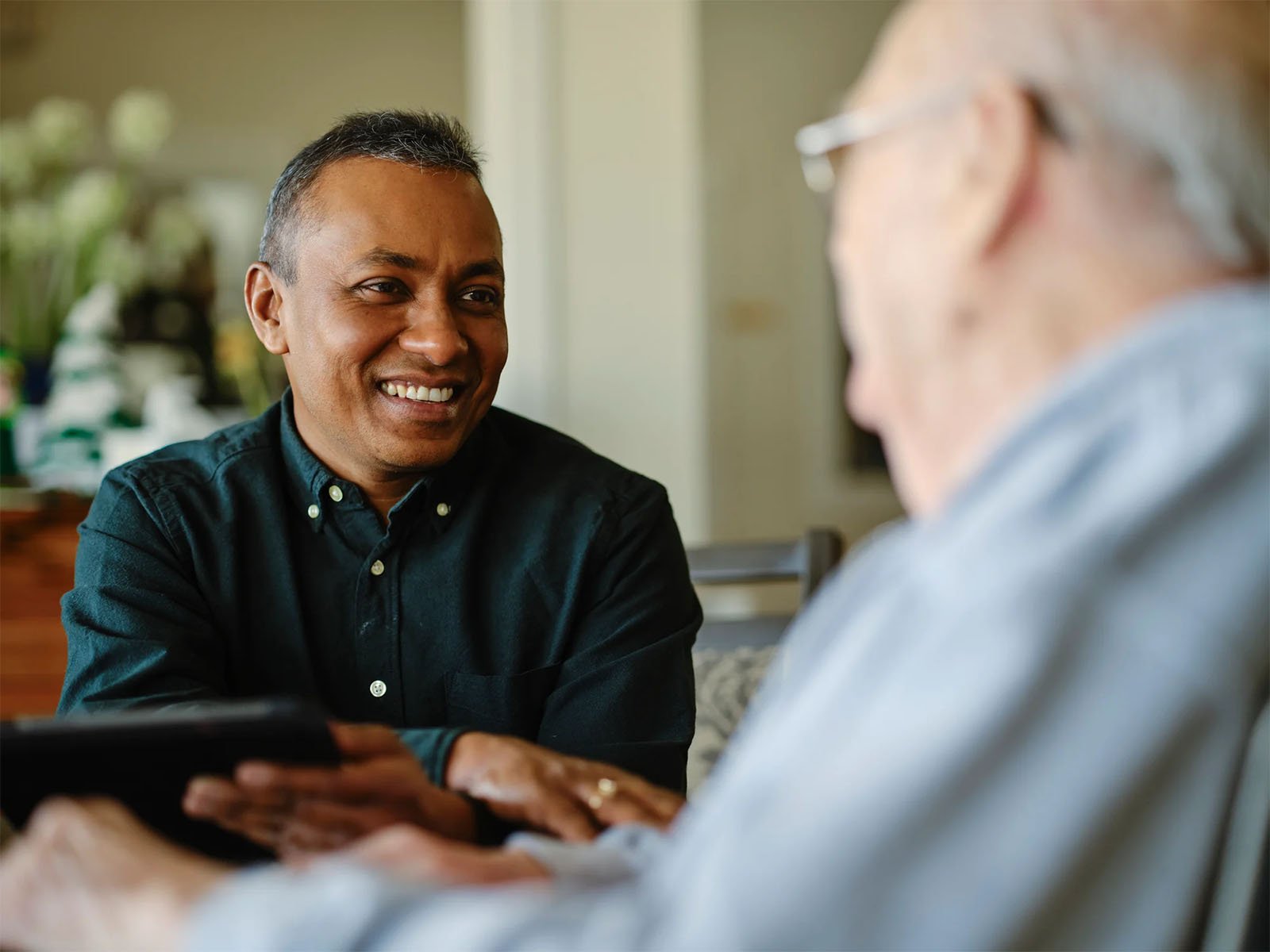 middle aged man smiling at an older man