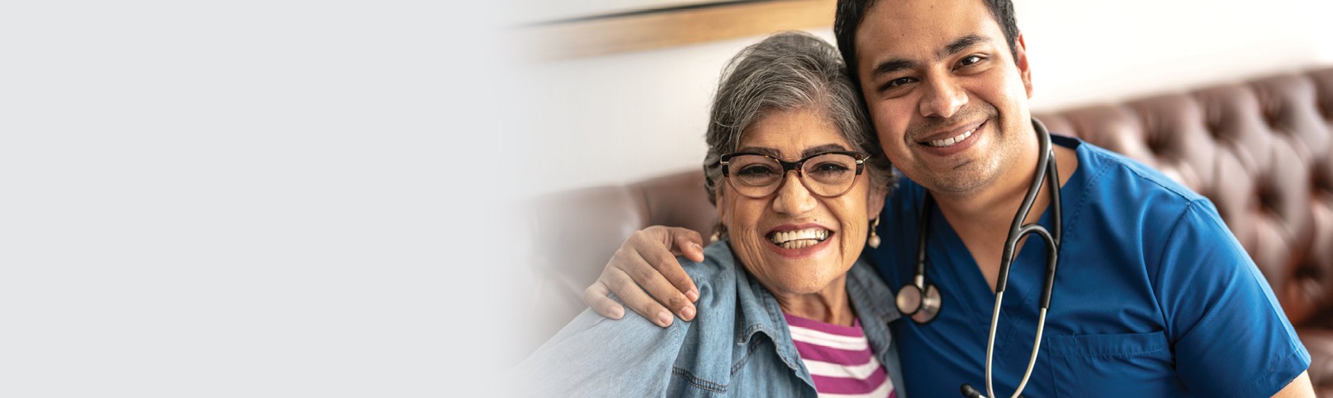 senior woman smiling with a male nurse