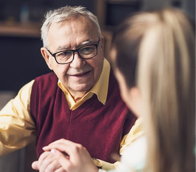 senior man talking with a female nurse