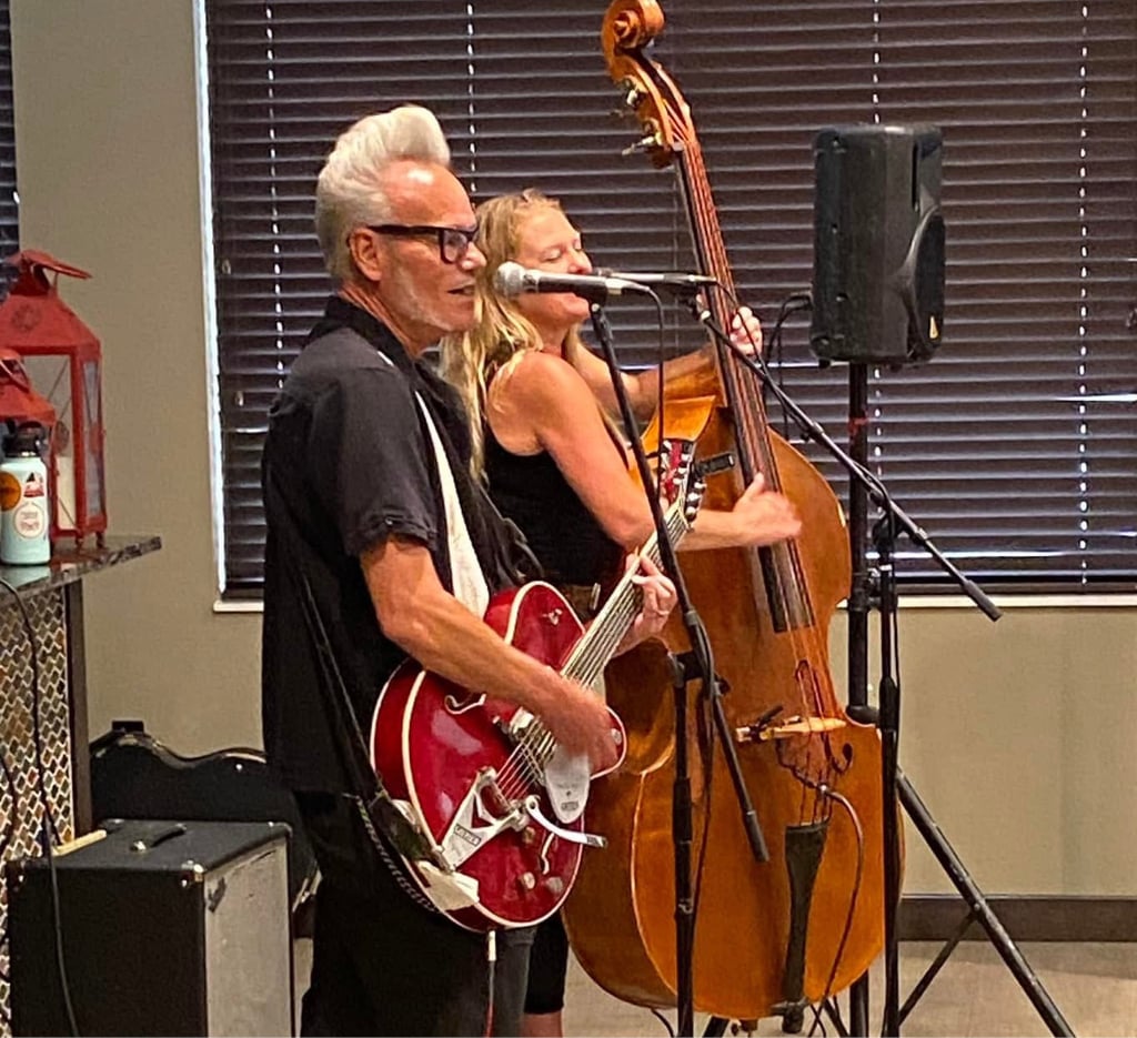 two senior adults playing instruments