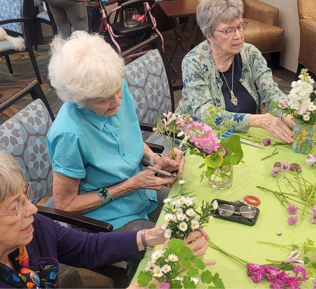 senior women making flower bouquets