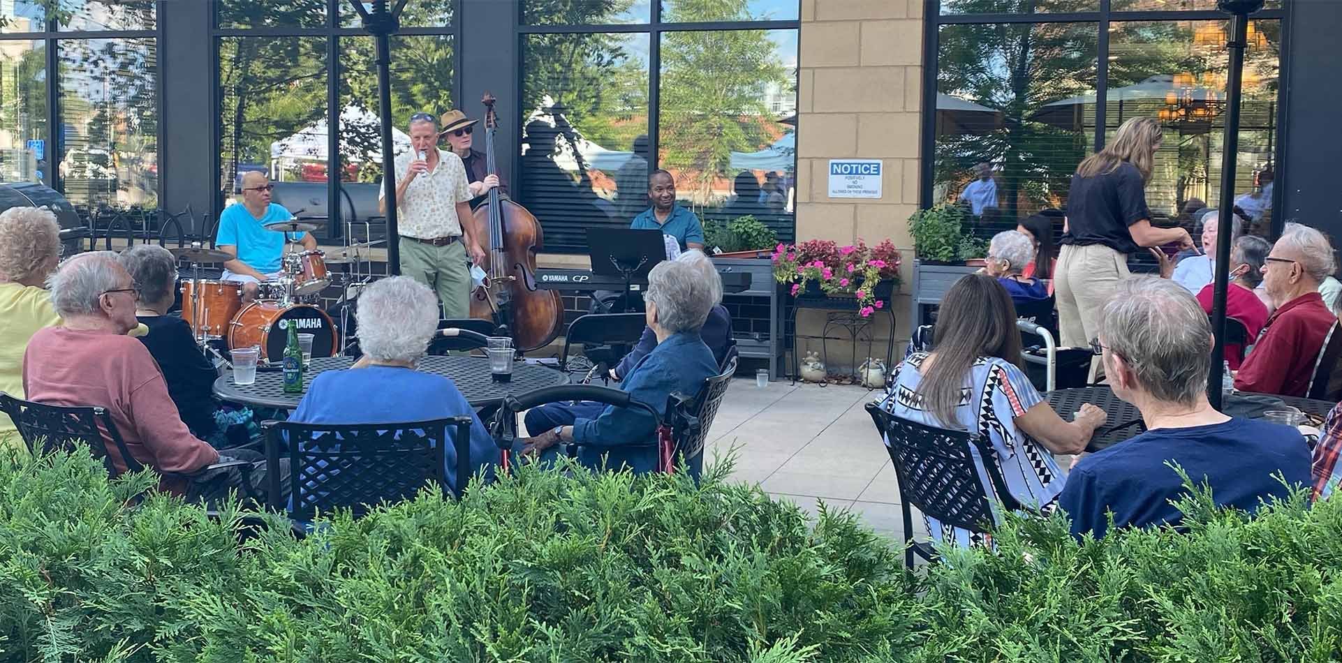 group of senior adults enjoying live music on the towerlight patio